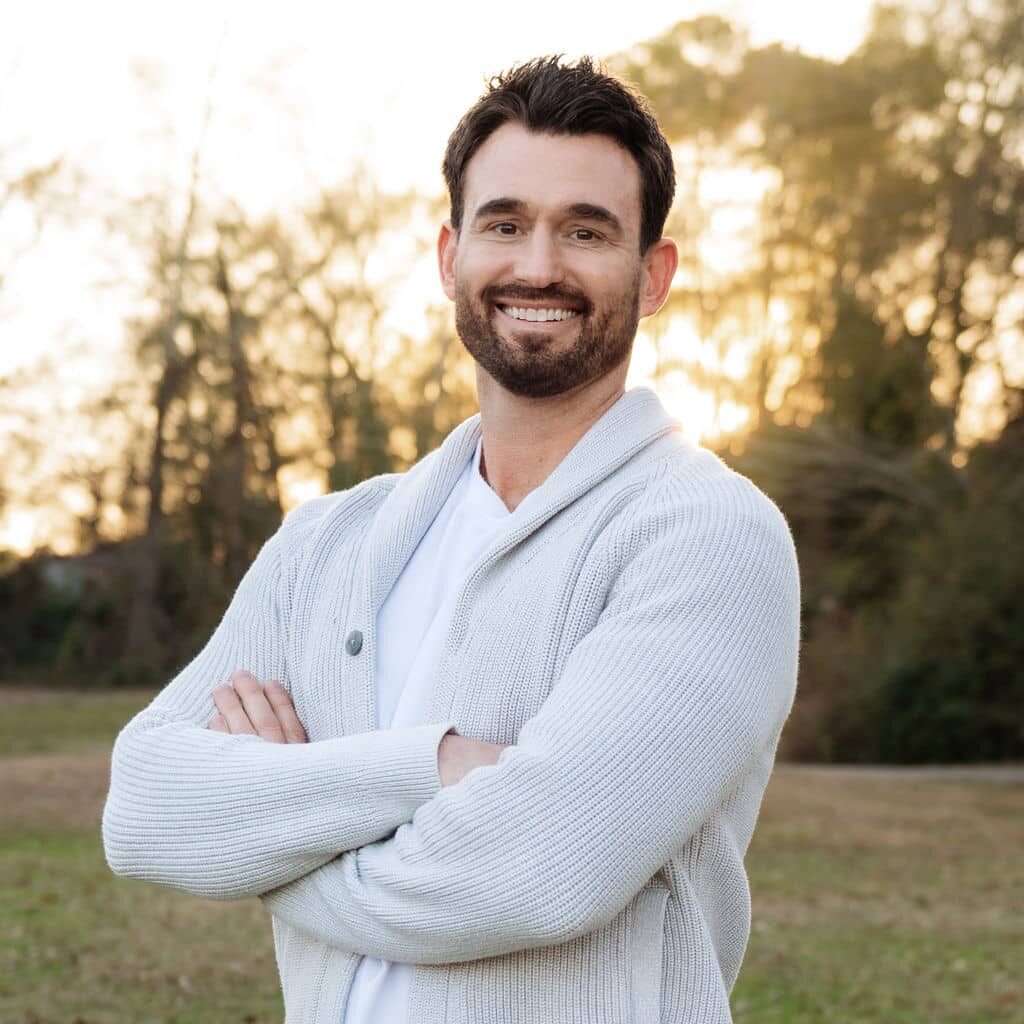 Dr. Steven Speaker, orthodontist, smiling outdoors with his arms crossed
